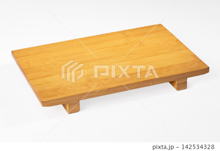 Rectangular bamboo tray with raised feet on white background Rectangular bamboo tray with raised feet on white background 142534328