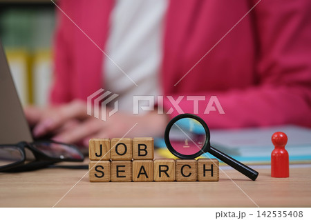 Exploring new opportunities with a job search and focused determination in a bright office setting Exploring new opportunities with a job search and focused determination in a bright office setting 142535408