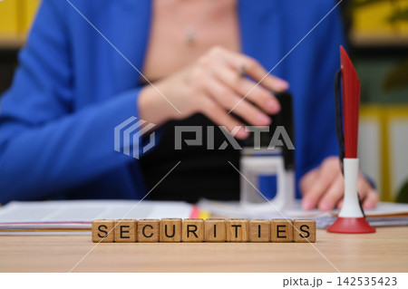 Business professional engaging in financial activities at a modern office desk during a productive workday 142535423