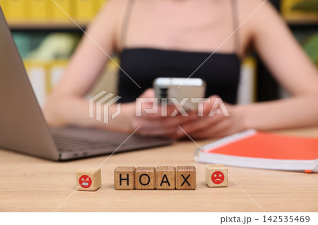 Exploring digital misinformation through playful engagement with word blocks at a cozy workspace 142535469
