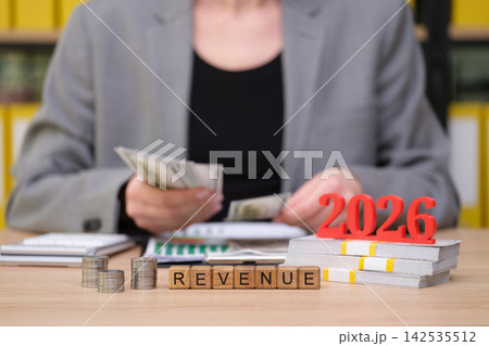 Counting cash and planning for the future in a modern workspace filled with financial insights in 2026 142535512