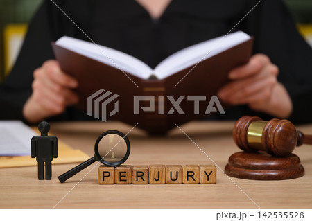 Courtroom scene highlighting the seriousness of perjury with a judge preparing for an important case 142535528