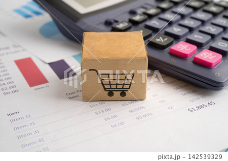 Online shopping, Shopping cart box on calculator, import export, finance commerce. Online shopping, Shopping cart box on calculator, import export, finance commerce. 142539329