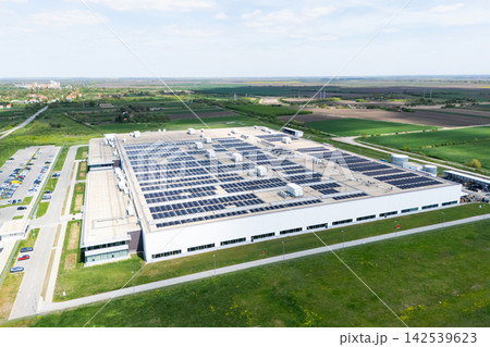 Aerial view of a modern logistics center with solar panels on the roof Aerial view of a modern logistics center with solar panels on the roof 142539623