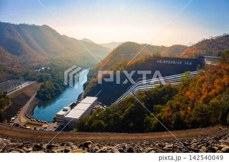 Landscape view around of Srinakarin Dam the power station with large mountains and many trees in morning at Kanchanaburi, Thailand. To generate electricity in the western region of the country Landscape view around of Srinakarin Dam the power station with large mountains and many trees in morning at Kanchanaburi, Thailand. To generate electricity in the western region of the country 142540049