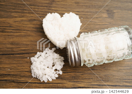 Sodium chloride sea salt with salt shaker. Sodium chloride sea salt with salt shaker. 142544629