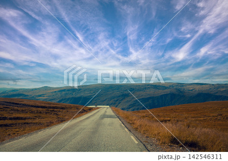 Driving a car on mountain road. Nature Norway. Polar circle. The way to Nordkapp Driving a car on mountain road. Nature Norway. Polar circle. The way to Nordkapp 142546311