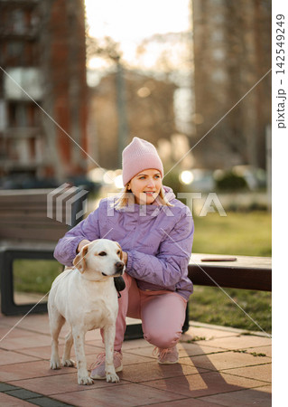 Young woman enjoying time with dog in urban park Young woman enjoying time with dog in urban park 142549249