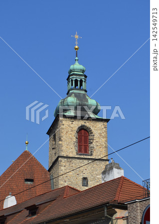 Historic prague church tower with green copper dome and red tiled roofs for travel background and architectural banner design Historic prague church tower with green copper dome and red tiled roofs for travel background and architectural banner design 142549713
