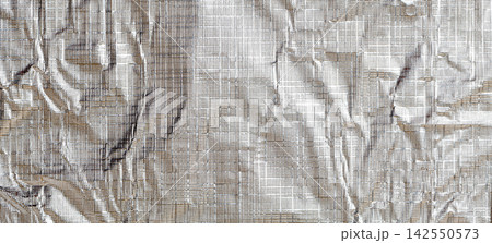Wrinkled silver foil reflecting light and textured surface 142550573