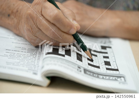 Bangkok, Thailand - May 15, 2022 elderly woman playing sudoku puzzle game. 142550961