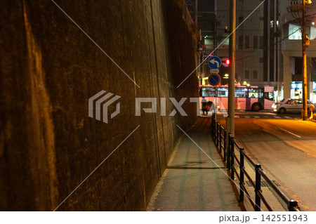 Night street corner with bus and traffic signs Night street corner with bus and traffic signs 142551943