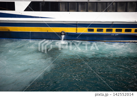 Blue and yellow ferry hull with churning wake Blue and yellow ferry hull with churning wake 142552014