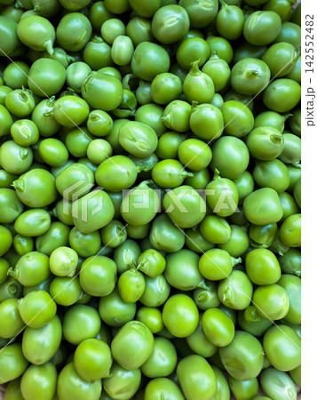 Green peas background showcasing fresh organic vegetables Green peas background showcasing fresh organic vegetables 142552482