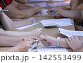 People Hands Filling Documents and Signing Papers at Table 142553499