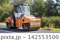 Orange Road Roller Compacting Fresh Asphalt outdoors 142553500