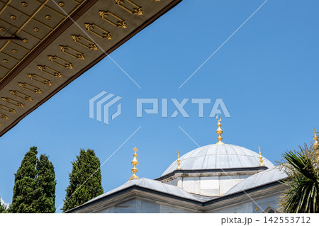 Istanbul,turkey,august 3, 2025. Topkapi palace, a historic site in istanbul, turkey, showcasing an ottoman style dome with a crescent finial and golden decoration Istanbul,turkey,august 3, 2025. Topkapi palace, a historic site in istanbul, turkey, showcasing an ottoman style dome with a crescent finial and golden decoration 142553712