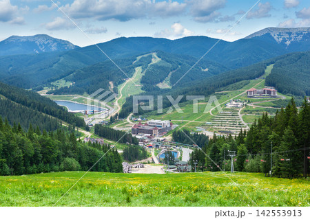 Beautiful view of the summer Carpathians Mountains with forest, lakes and hotels in resort Bukovel, Ukraine Beautiful view of the summer Carpathians Mountains with forest, lakes and hotels in resort Bukovel, Ukraine 142553913