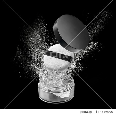 Loose powder compact with open lid and makeup puff floating above sparkling white particles on black studio background Loose powder compact with open lid and makeup puff floating above sparkling white particles on black studio background 142556090