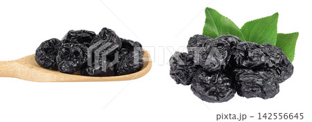 Prunes in wooden spoon isolated on white background, heap of dried plums Prunes in wooden spoon isolated on white background, heap of dried plums 142556645