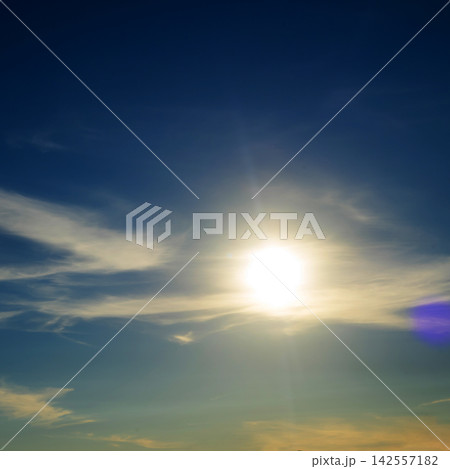 bright sun shines brightly in a blue sky with translucent feathery clouds on a clear day bright sun shines brightly in a blue sky with translucent feathery clouds on a clear day 142557182
