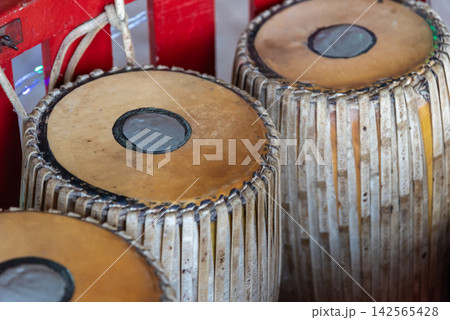 Traditional Indian tabla drums leather membranes wooden bodies woven straps representing classical music rhythm culture handcrafted percussion Traditional Indian tabla drums leather membranes wooden bodies woven straps representing classical music rhythm culture handcrafted percussion 142565428