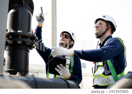 Team man engineer inspection pipe tablet, industrial rooftop safety maintenance. 142565805