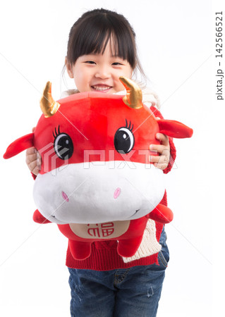 Smiling little girl hugging a red ox plush toy, celebrating the Year of the Ox, Chinese New Year theme.The Chinese character embroidered above: "Fu" (Good Fortune) 142566521