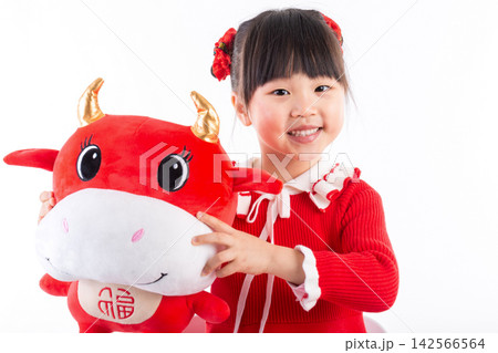 Smiling little girl hugging a red ox plush toy, celebrating the Year of the Ox, Chinese New Year theme.The Chinese character embroidered above: "Fu" (Good Fortune) Smiling little girl hugging a red ox plush toy, celebrating the Year of the Ox, Chinese New Year theme.The Chinese character embroidered above: "Fu" (Good Fortune) 142566564