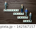Business people standing on tiles showing path to success 142567157