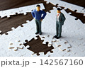 Businessmen finding missing puzzle piece for solution 142567160