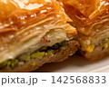 Traditional Turkish baklava served on a white plate close-up 142568833