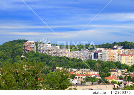 Modern concrete apartment buildings nestled on green hills outside an Eastern European city Modern concrete apartment buildings nestled on green hills outside an Eastern European city 142569370