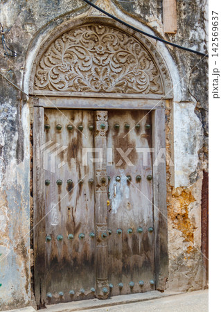 Traditional wooden carved door in Stone Town, Zanzibar, Tanzania Traditional wooden carved door in Stone Town, Zanzibar, Tanzania 142569637