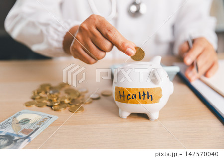 Healthcare professional placing a coin into a piggy bank labeled Health, representing medical savings, healthcare costs, insurance budgeting, financial protection, emergency funds, and future care. Healthcare professional placing a coin into a piggy bank labeled Health, representing medical savings, healthcare costs, insurance budgeting, financial protection, emergency funds, and future care. 142570040