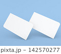 Blank white cards on a blue background used for various purposes like notes, invitations, or creative projects 142570277