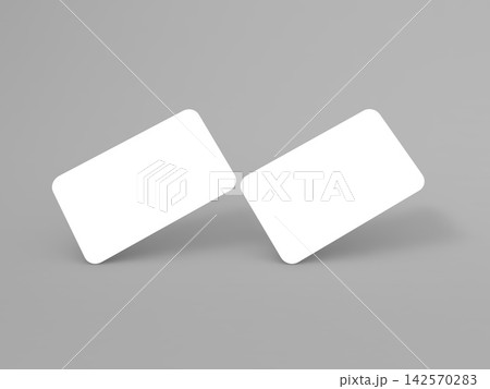 Blank business cards placed at an angle on a gray background for design 142570283