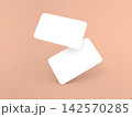 Two blank cards placed at an angle on a soft peach background 142570285