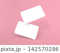 Blank cards floating in the air above a pink background 142570286