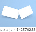 Two blank cards displayed at an angle on a light blue background 142570288
