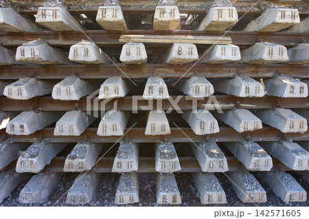 Rusty intermediate rail fasteners on concrete sleepers for train and tram, laying railroad tracks 142571605