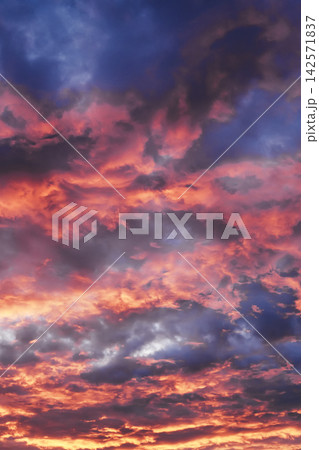 Sunset sky showing colorful clouds illuminated with red and orange light Sunset sky showing colorful clouds illuminated with red and orange light 142571837