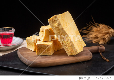 Slices of crunchy sponge honeycomb candy served on a wooden tray Slices of crunchy sponge honeycomb candy served on a wooden tray 142572007