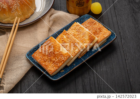 traditional Xinjiang Layered Naan Flatbread, Golden Crispy Roasted Bread with Sesame traditional Xinjiang Layered Naan Flatbread, Golden Crispy Roasted Bread with Sesame 142572023