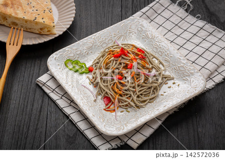 chinese cold tossed black soybean tofu shreds salad with chili oil and onion, traditional spicy Asian appetizer 142572036