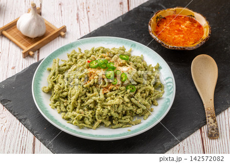 chinese traditional roasted green wheat noodles, handmade Nianzhuan with chili oil flavoring, healthy asian vegan food chinese traditional roasted green wheat noodles, handmade Nianzhuan with chili oil flavoring, healthy asian vegan food 142572082