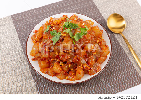 farmhouse style stir-fried sweet potato starch jelly with spicy chili sauce on a rustic wooden tray 142572121