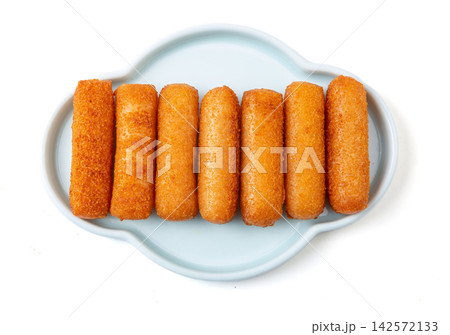 crispy fried glutinous rice cakes served on a Light-colored ceramic plate with brown sugar syrup and soybean powder dips crispy fried glutinous rice cakes served on a Light-colored ceramic plate with brown sugar syrup and soybean powder dips 142572133