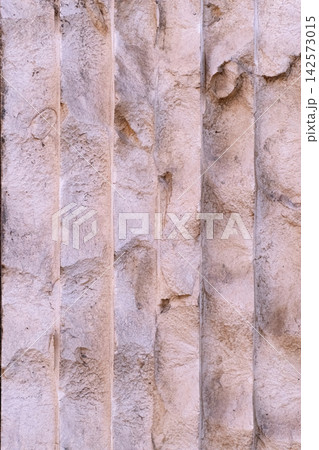 Aged stone texture featuring vertical flutes and worn details, creating an abstract background for architectural and historical themes Aged stone texture featuring vertical flutes and worn details, creating an abstract background for architectural and historical themes 142573015