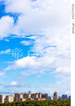 blue sky with large white cloud over city district blue sky with large white cloud over city district 142573535